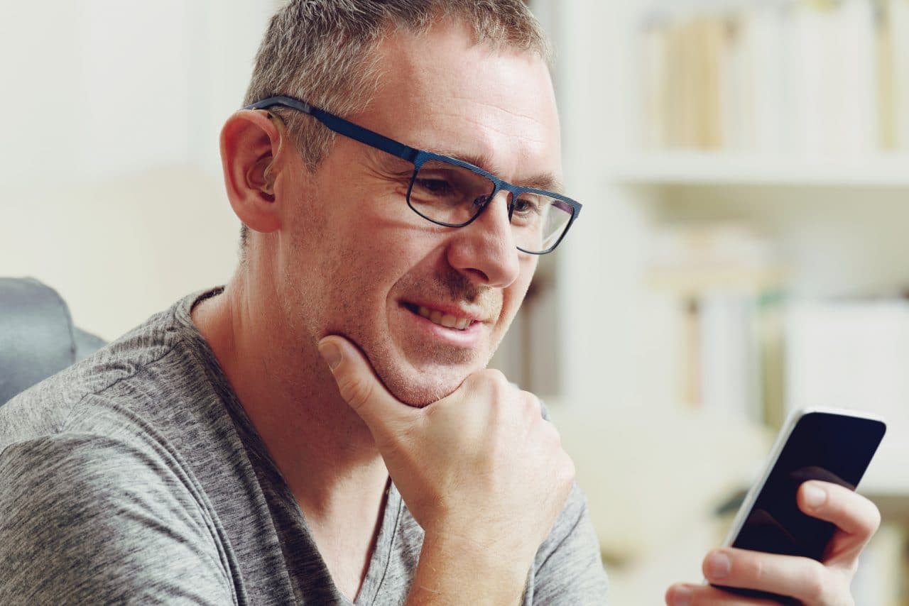 Hearing impaired man with hearing aid