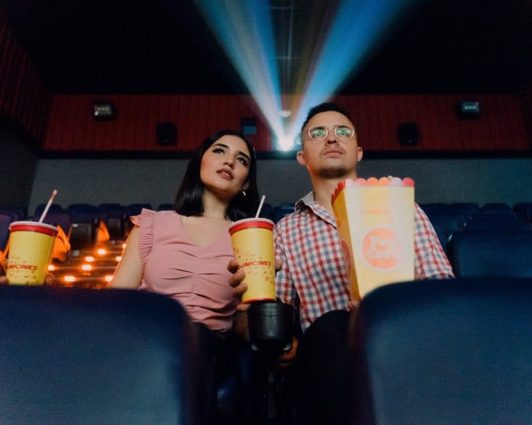 Woman and man at a movie theater. Telecoil technology is often an option in public places like movie theaters.