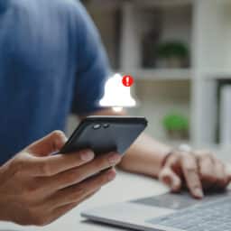 Man holding his phone with a new alert
