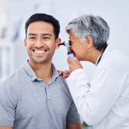 Happy man in an ear exam