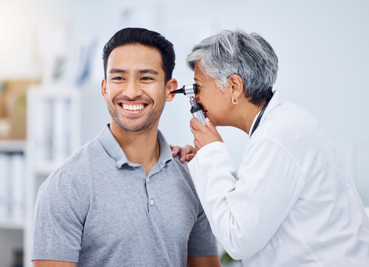 Happy man in an ear exam.