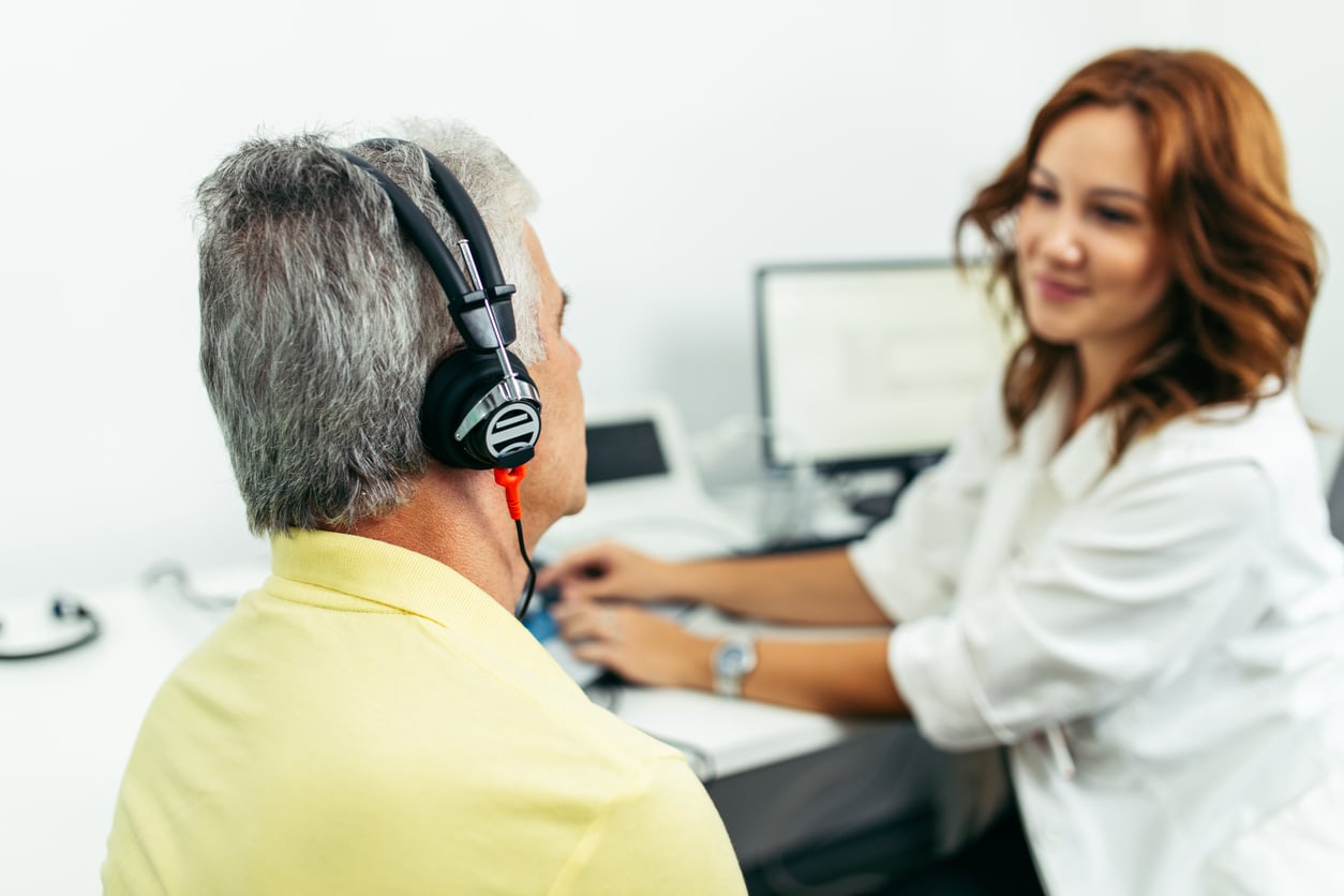 Audiologist administering a hearing test.